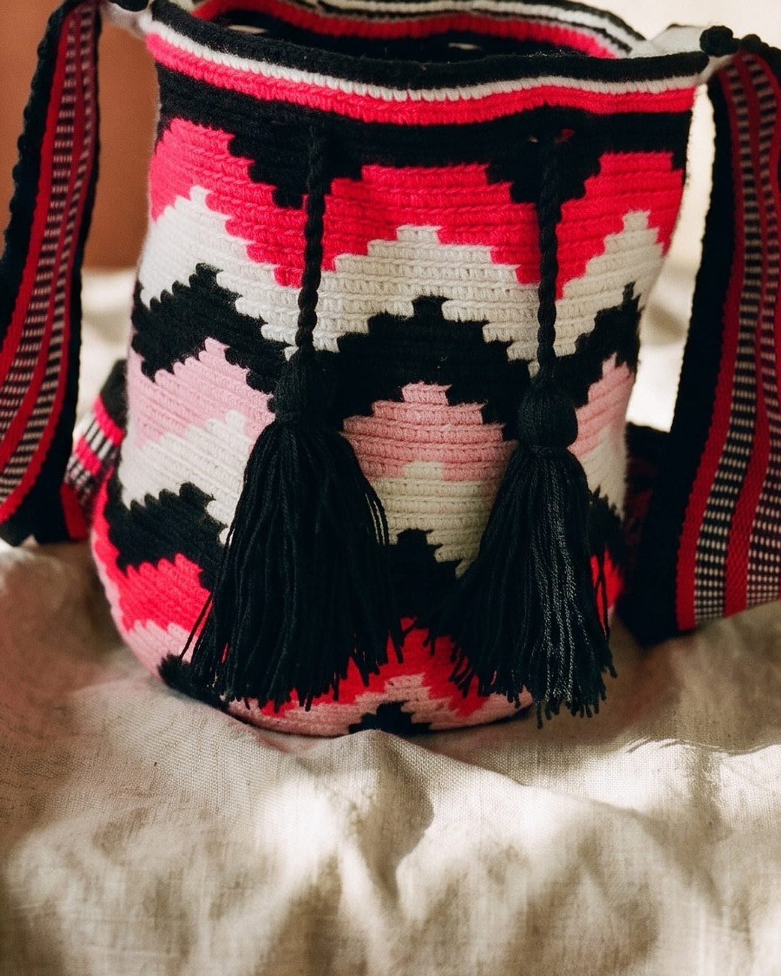 Detailaufnahme der Mochila: Gewebe, Muster und geflochtene Quasten aus der Nähe.